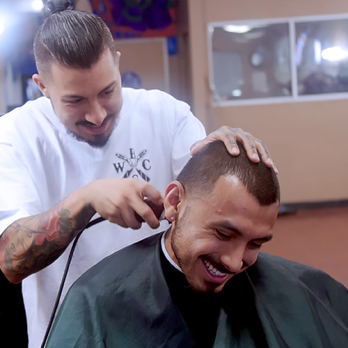 Patient getting haircut at barber shop.