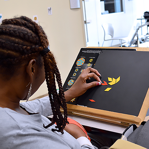 Woman working on puzzle.