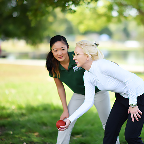 Therapist playing Bocce ball with a patient.