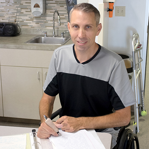 Patient writing a letter as part of his speech therapy.